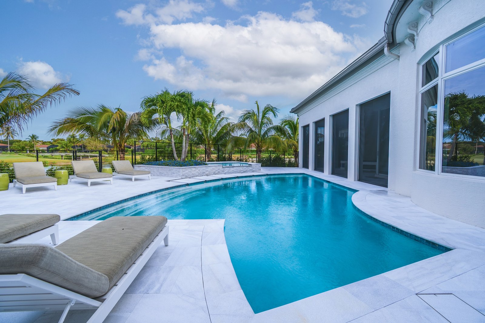 Clear pool water perspective with luxury home backdrop
